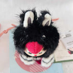 A top view of a Labubu Dive Into Love plush doll, shows it's black head and long ears.