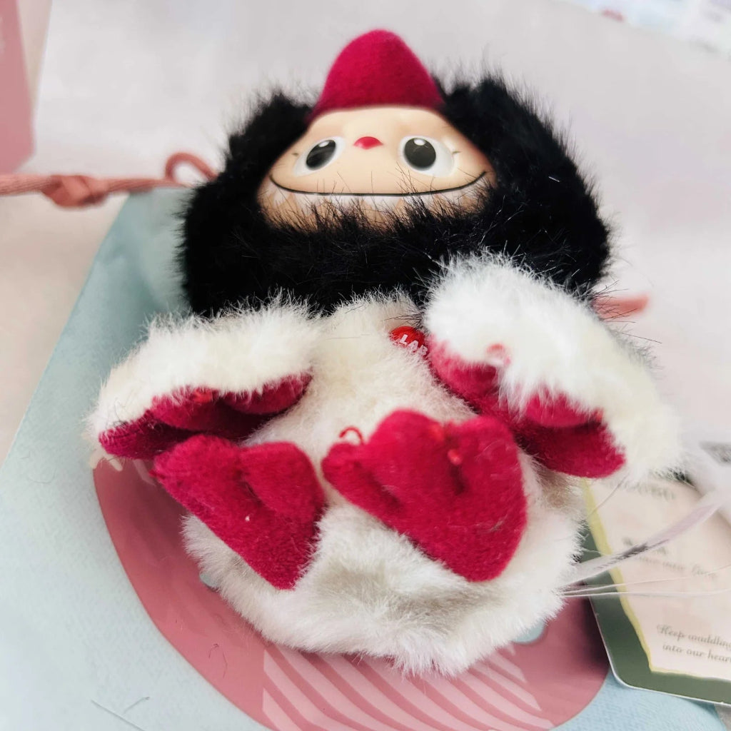 A Labubu Dive Into Love plush doll with fuzzy black and white body.