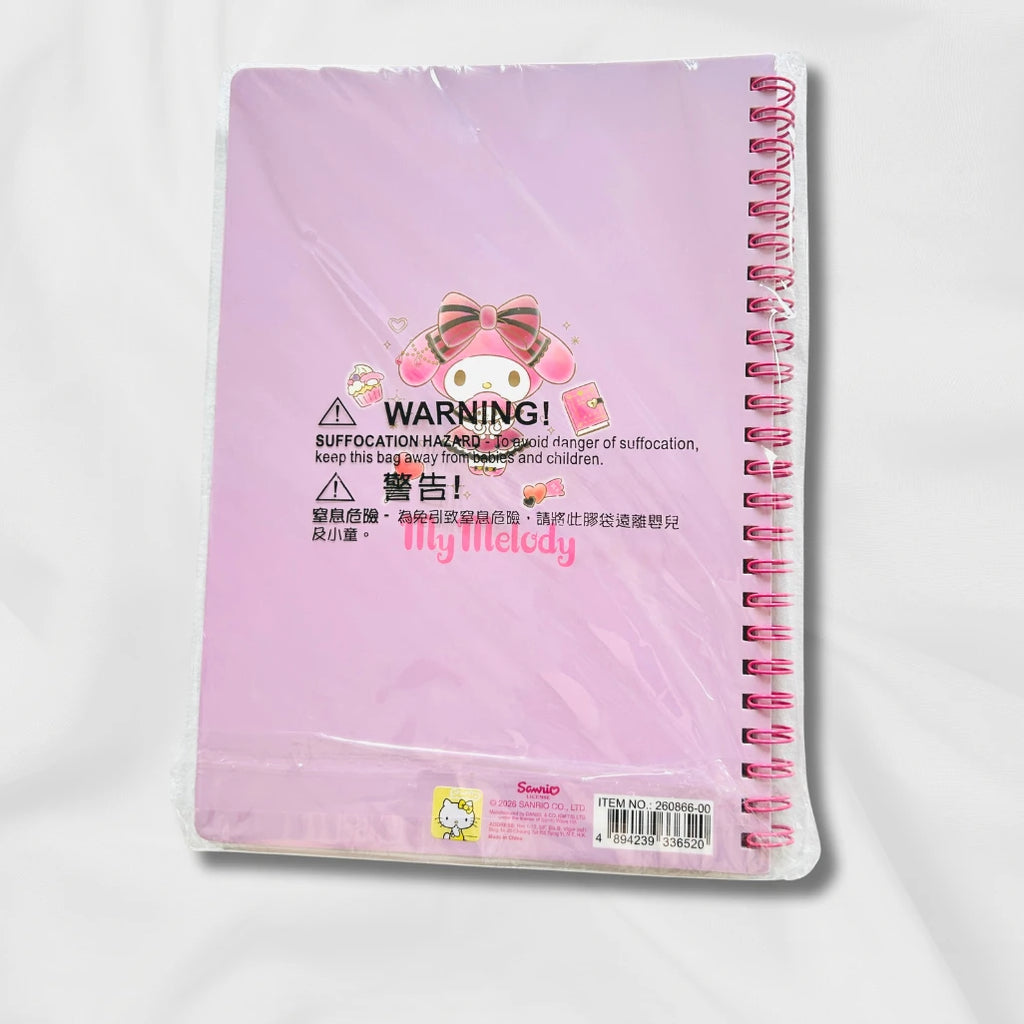 A pink spiral notebook in clear plastic packaging, featuring a My Melodyr illustration and warning label.

