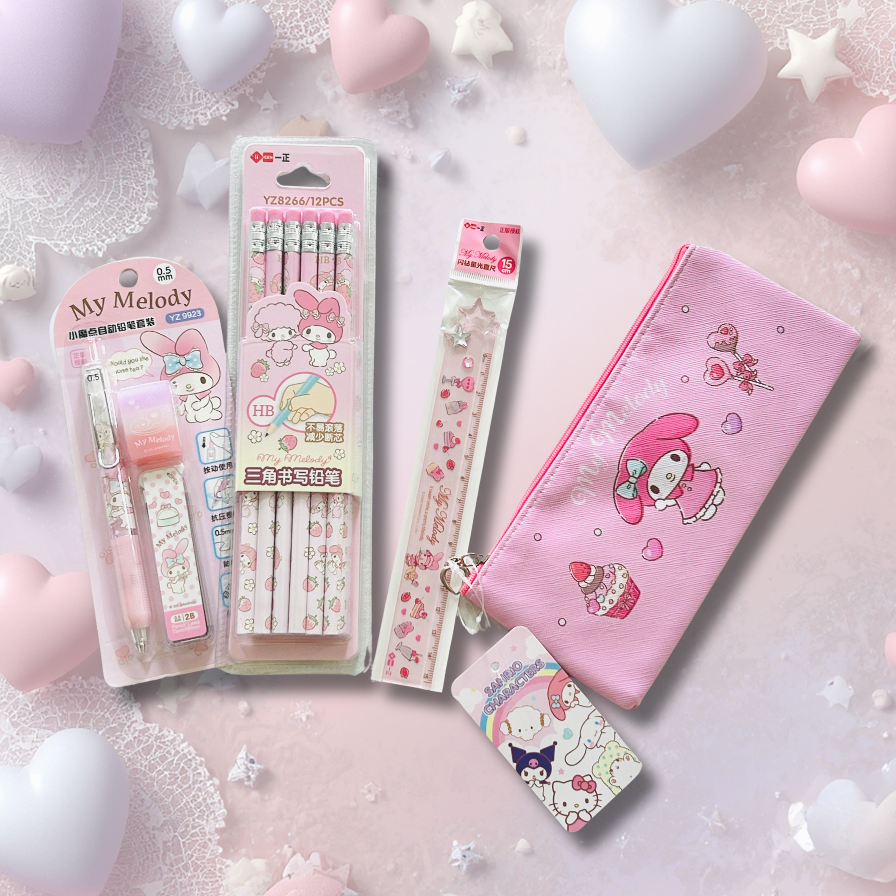 A flat-lay arrangement of Sanrio My Melody stationery items. The set includes a pink pen, a packaged set of patterned pencils, a long decorative pen, a pink zip pouch.