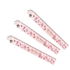 Three clear plastic rulers with pink and My Melody themed patterns, including cakes, hearts, stars.