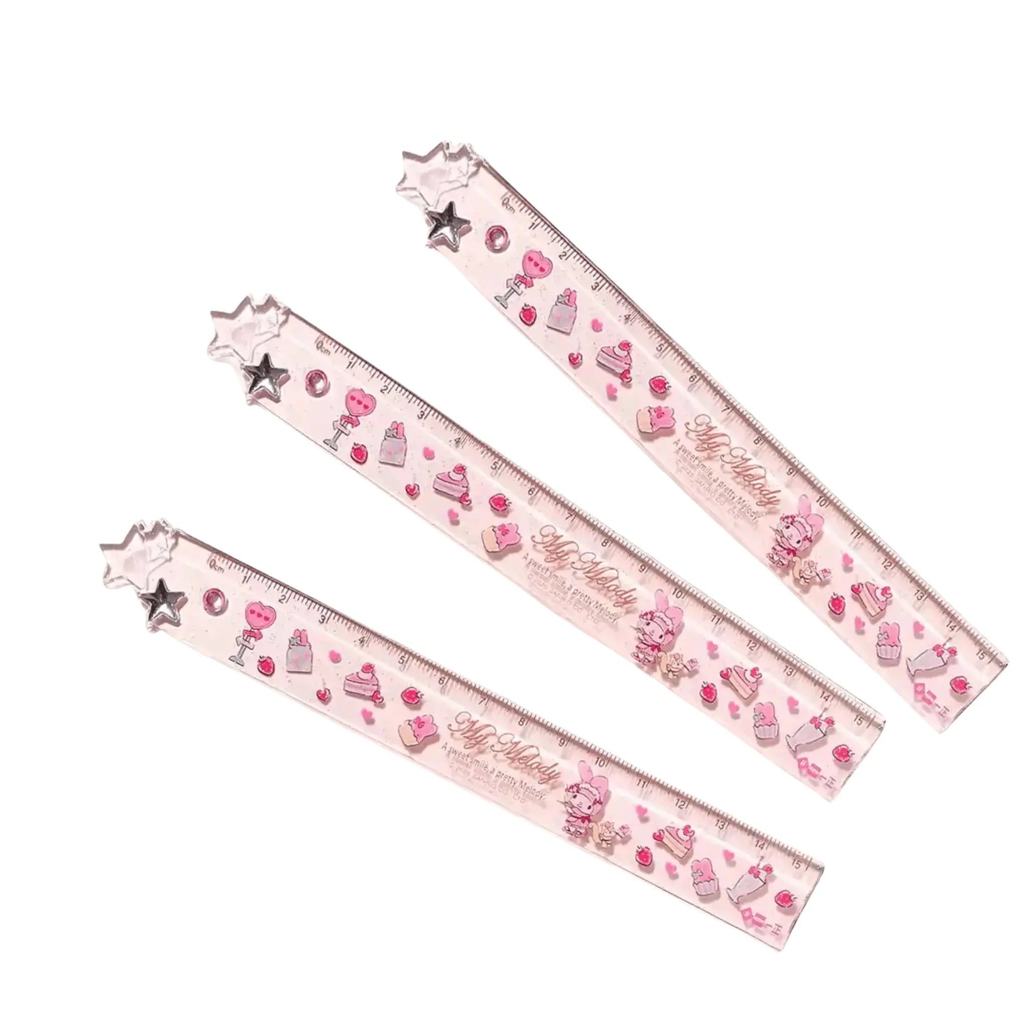 Three clear plastic rulers with pink and My Melody themed patterns, including cakes, hearts, stars.