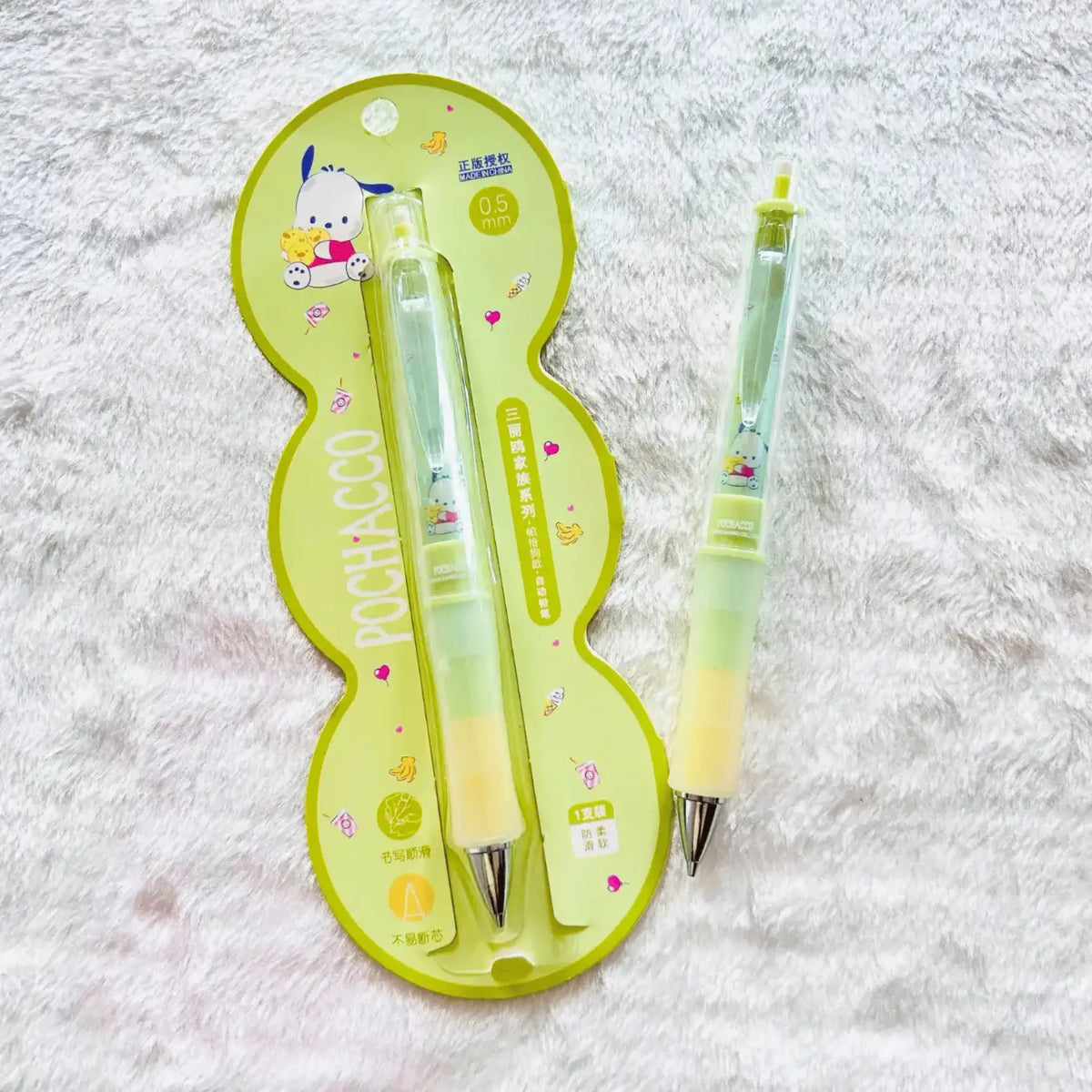 Two Pochacco-themed mechanical pencils with a translucent green and yellow body, displayed on a light green Pochacco-shaped card.