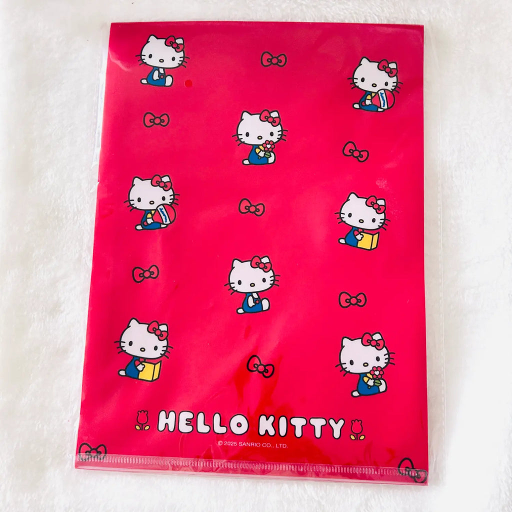 A bright pink Hello Kitty file folder with a glossy finish, featuring printed illustrations of Hello Kitty in blue and yellow outfits, bows, and the 'HELLO KITTY' logo at the bottom.