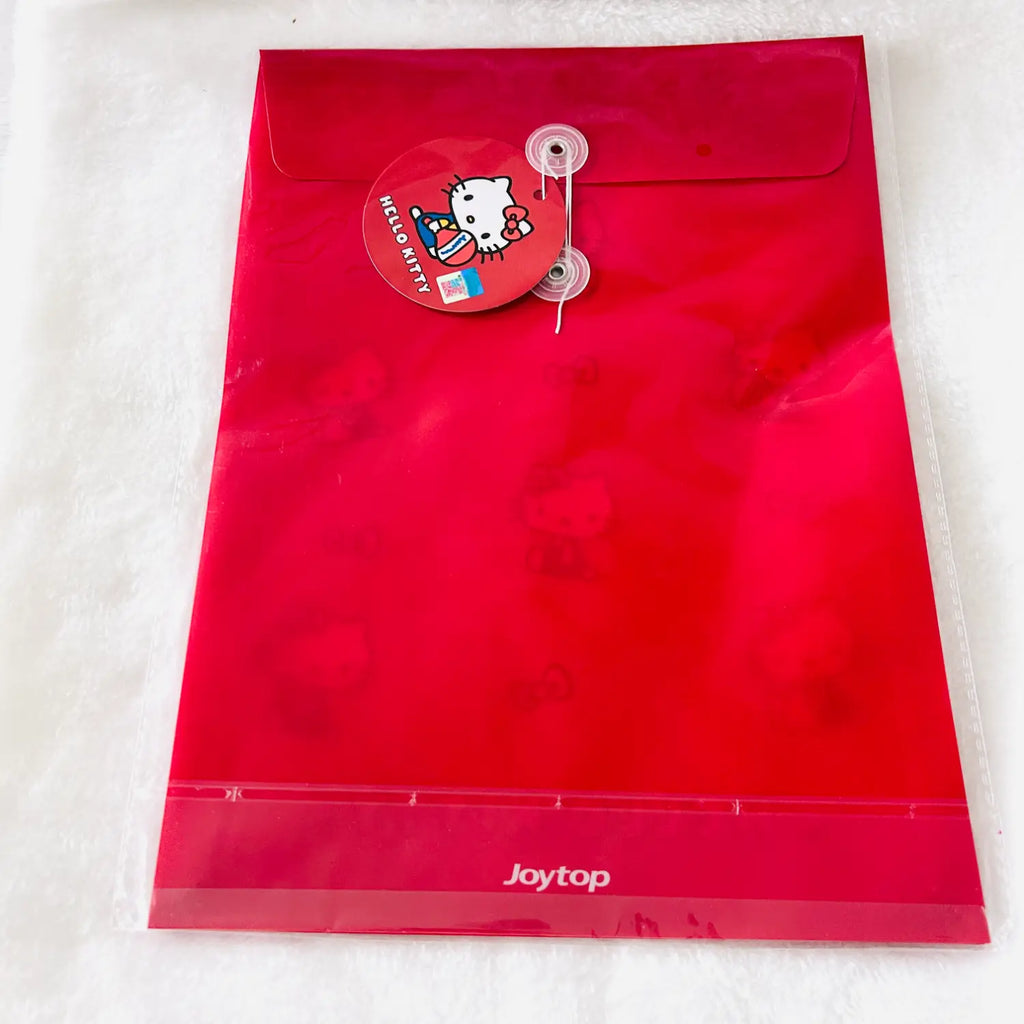 A red Joytop Hello Kitty file folder with a clear plastic sleeve, featuring a red hanging tag with the Hello Kitty character and a white textured background.