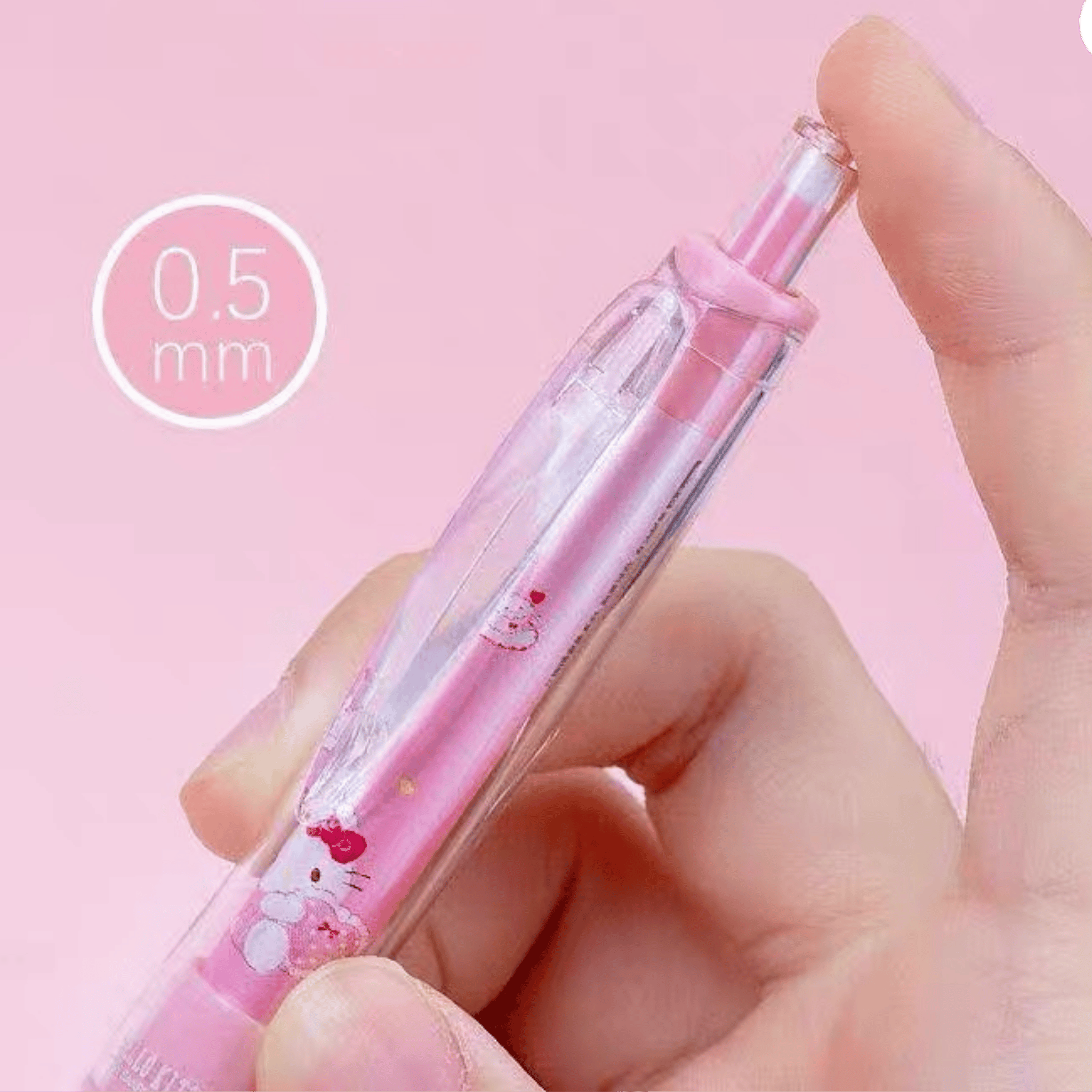 A hand holding a pink Hello Kitty retractable mechanical pencil, against a solid pink background with a '0.5 mm' size callout graphic.