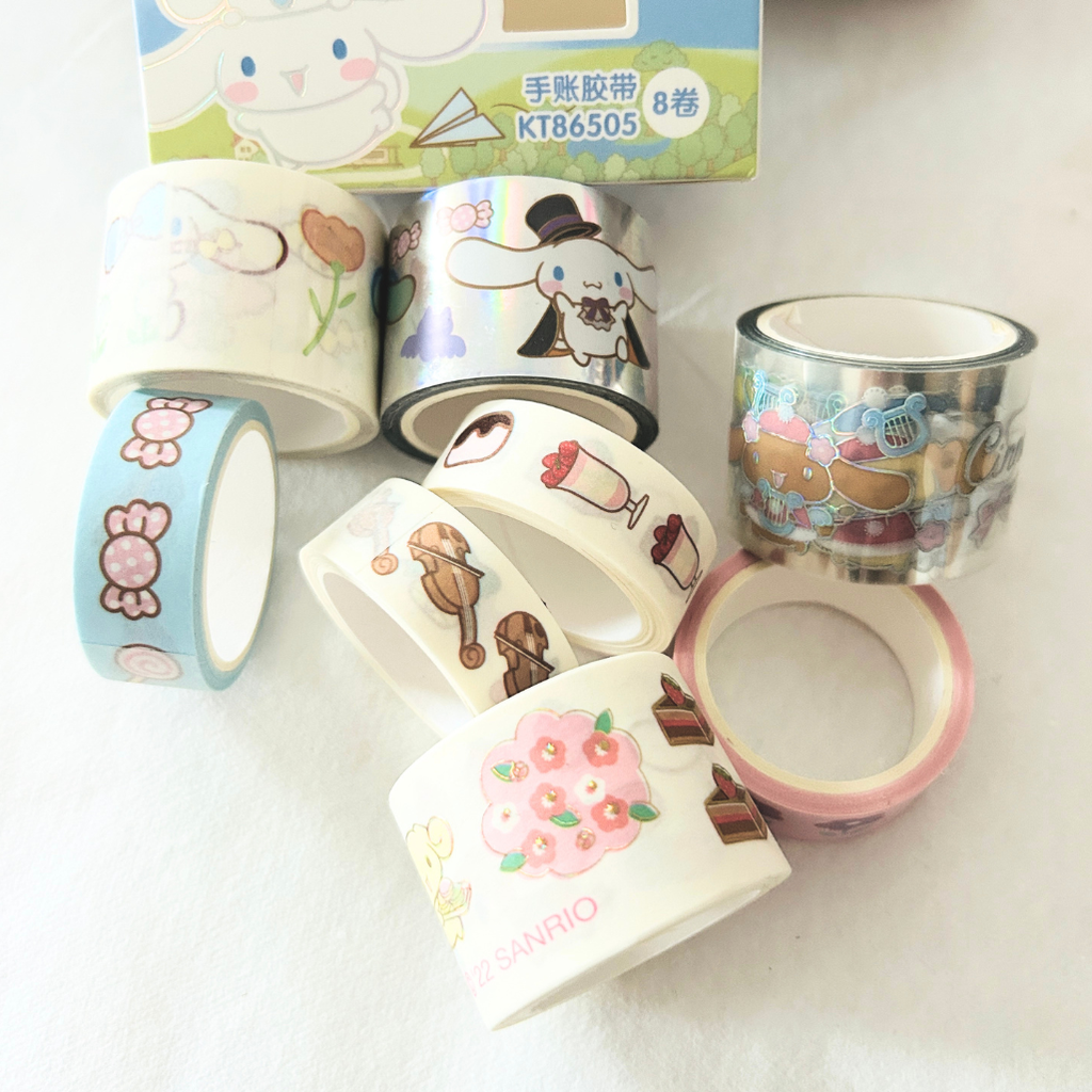 A set of Sanrio-themed washi tapes with various cute character designs, displayed alongside their product packaging box on a white background.