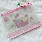 A mesh zippered pouch featuring Hello Kitty illustrations, pink trim, and a hanging Sanrio tag.