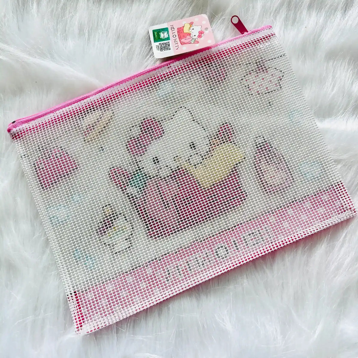 A mesh zippered pouch featuring Hello Kitty illustrations, pink trim, and a hanging Sanrio tag.