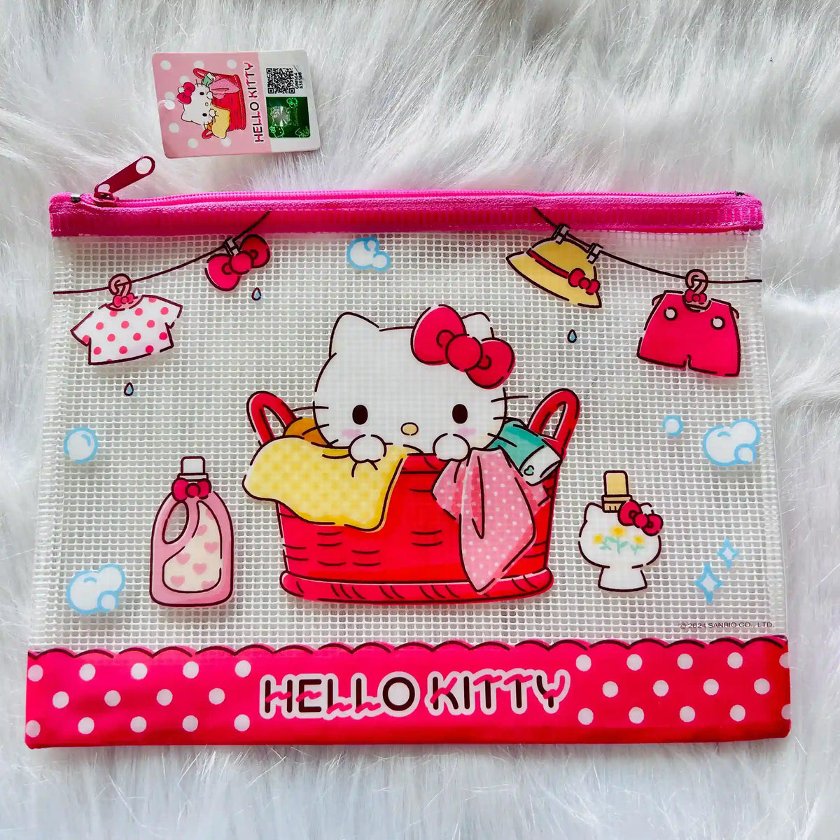 A Hello Kitty zippered pouch featuring an illustration of Hello Kitty in a laundry basket with colourful clothes and accessories.  