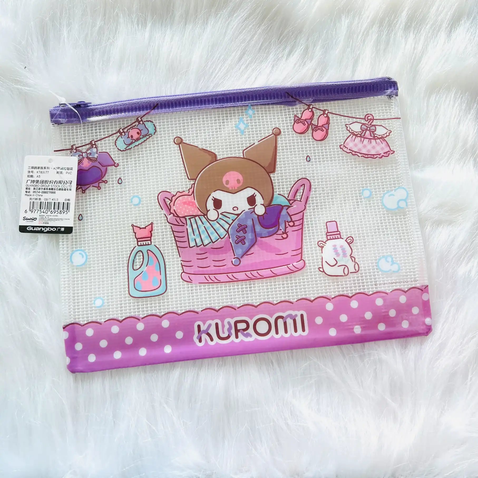 A clear mesh zippered pouch featuring Kuromi from Sanrio. The pouch has a purple zipper, a pink and white Kuromi graphic in a laundry basket.