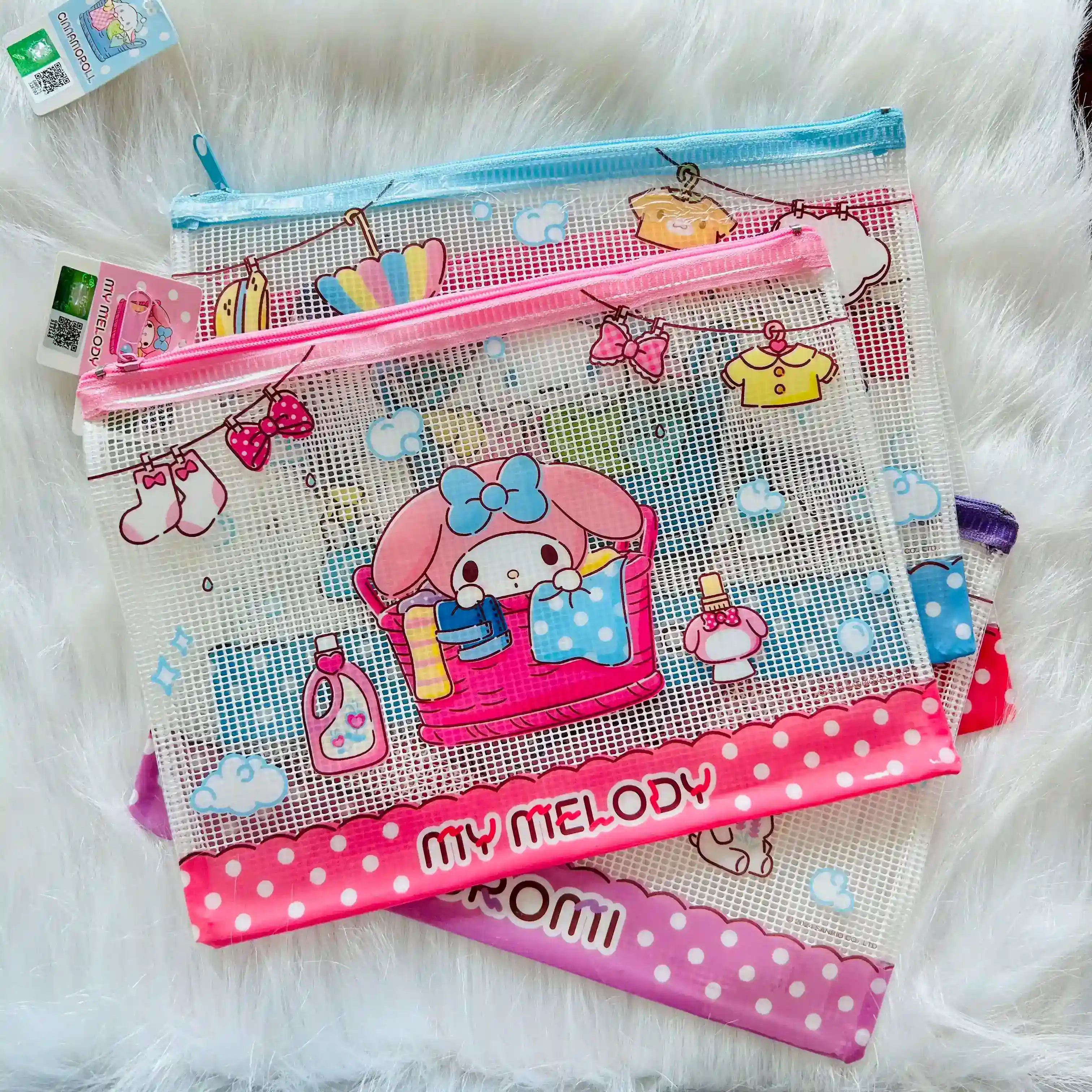 A stack of My Melody themed mesh zipper pouches in various sizes, decorated with pink and blue cartoon graphics.