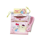 A Hello Kitty Pompompurin drawstring bag in pink gingham with a pink comb. The bag has a hanging paper tag reading Hello Kitty and Pompompurin.