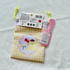 A small Hello Kitty-themed pouch with a yellow-and-white gingham pattern and a cartoon illustration.