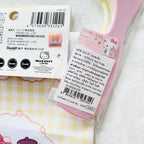A Hello Kitty hair comb's product information in Thai, and the drawstring bag package shows certificate mark.