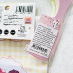 A Hello Kitty hair comb's product information in Thai, and the drawstring bag package shows certificate mark.