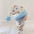 A Labubu doll wearing a white patterned pyjamas set with a light blue cuff and a matching light blue star-shaped hat.