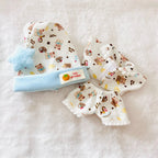A Labubu doll pyjamas set including a top and pants with bears patterned, with a light blue hat.