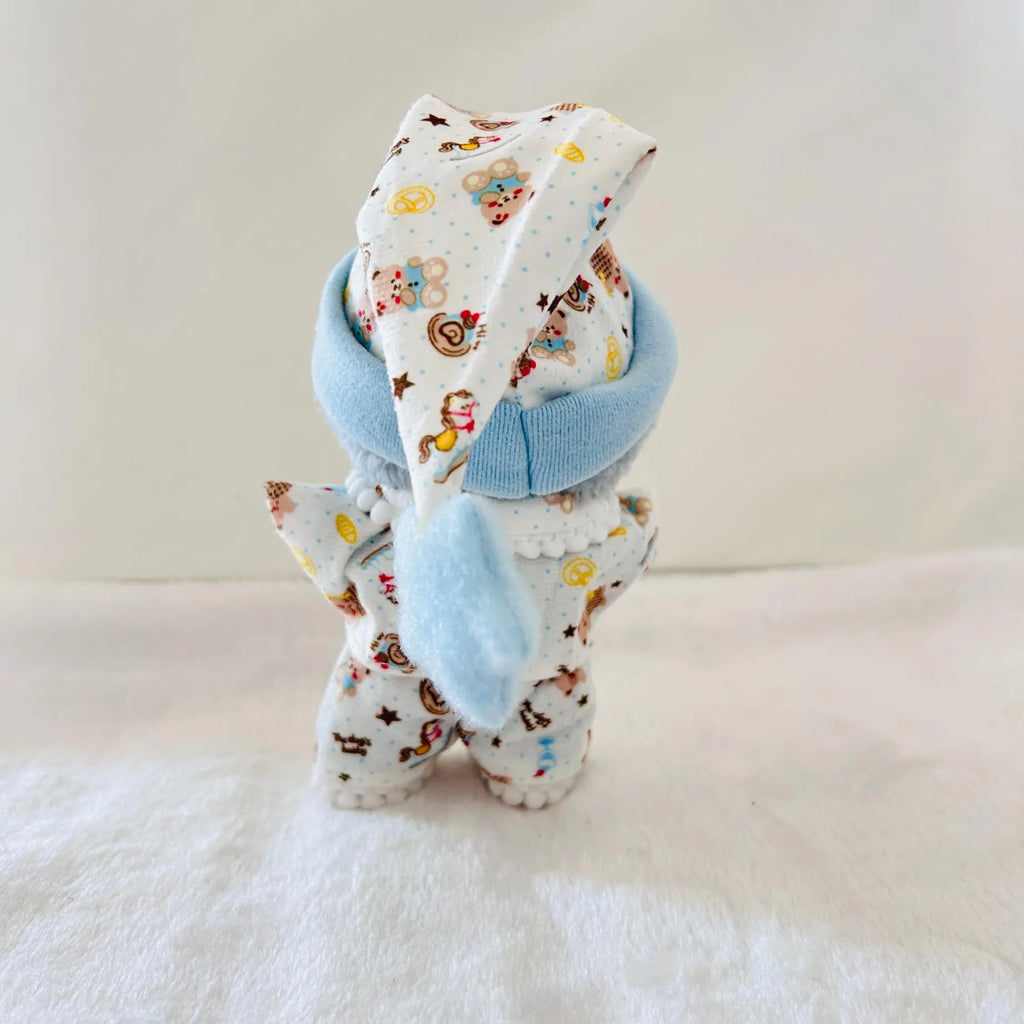 A back view of a Labubu doll dressed in a white and blue outfit with a colourful cartoon print.