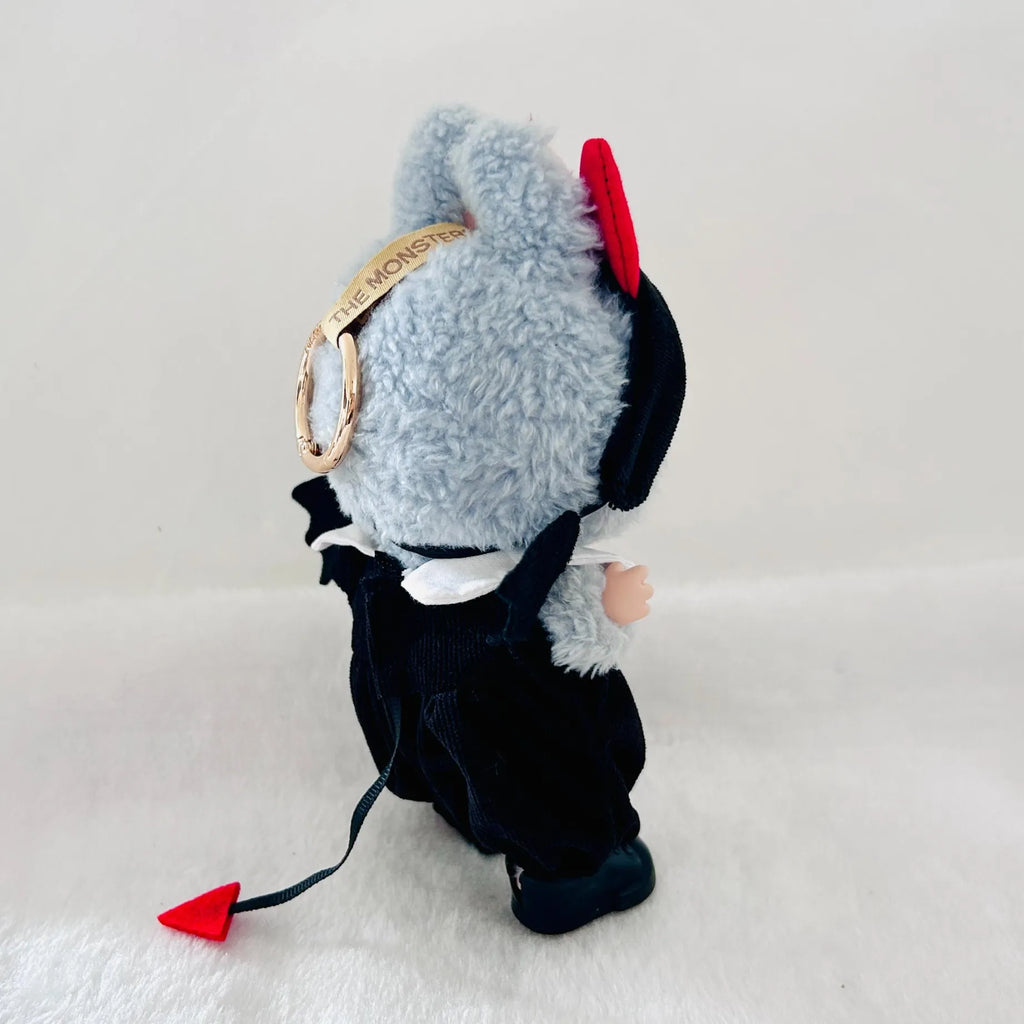 A Labubu doll shown from the back, featuring a black outfit with a small red tail.