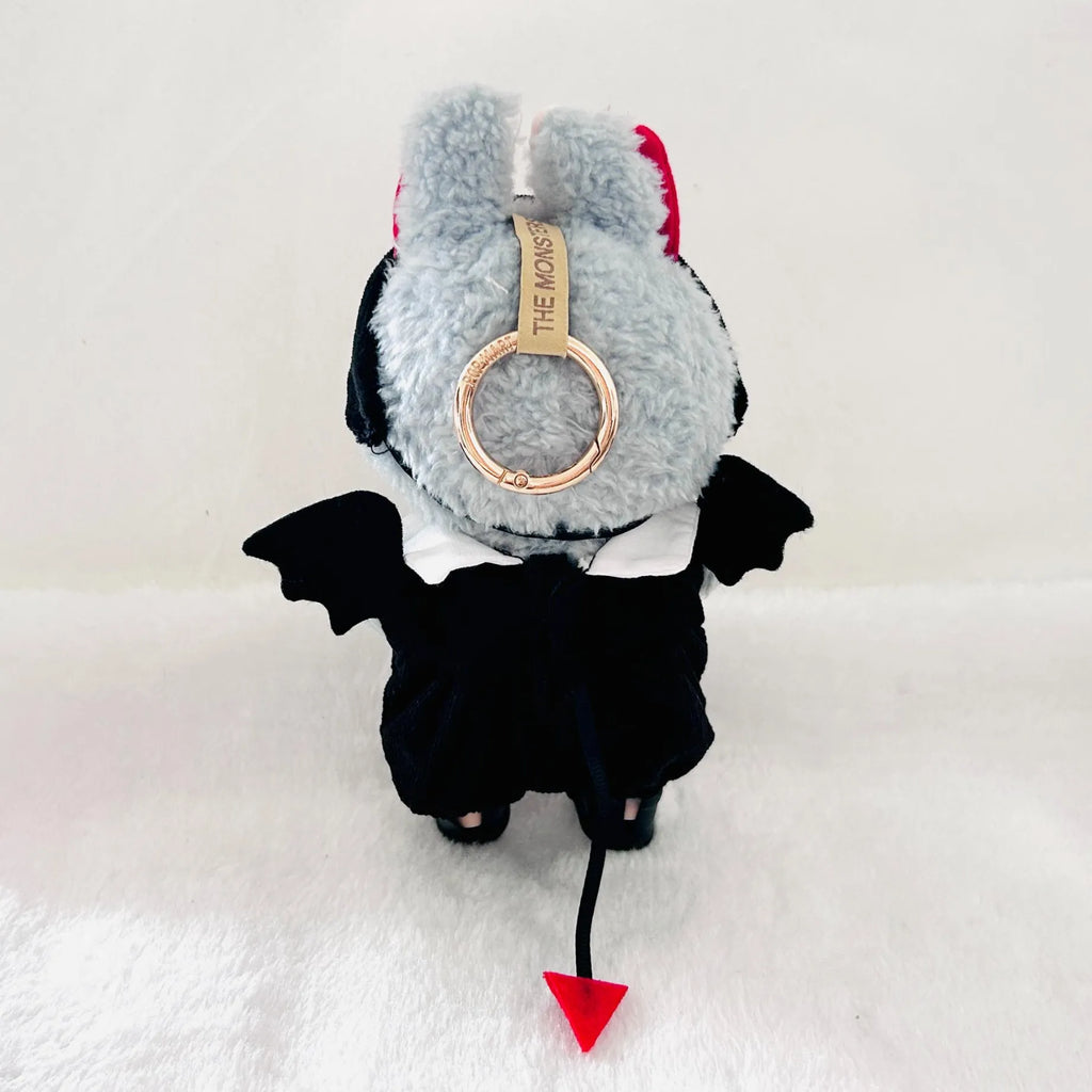 A back view of Labubu wearing a black  devil costume with bat wings, a red tail tip.