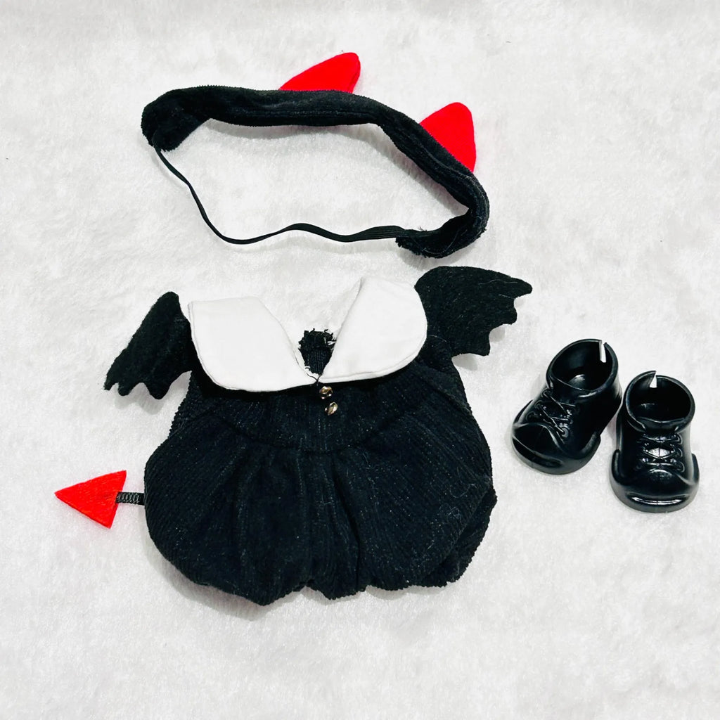A Labubu doll devil costume set including a black jumpsuit with black wings, a black headband with red horns, a red tail tip, and black shoes.