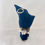 A small wizard or gnome figurine with a tall dark blue pointed hat, a patterned scarf.