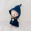 A Labubu plush doll wearing a dark navy blue pointed hooded coat with a plaid scarf.