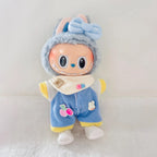 A Labubu plush doll wearing blue corduroy overalls with yellow trim, a cream bib, and white shoes.