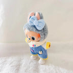 A Labubu plush doll wearing a light blue bow, and a blue striped outfit with yellow trim.