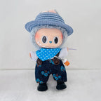 A cute doll character wearing a blue woven hat, a blue polka-dot bandana, dark blue floral overalls, and black shoes.