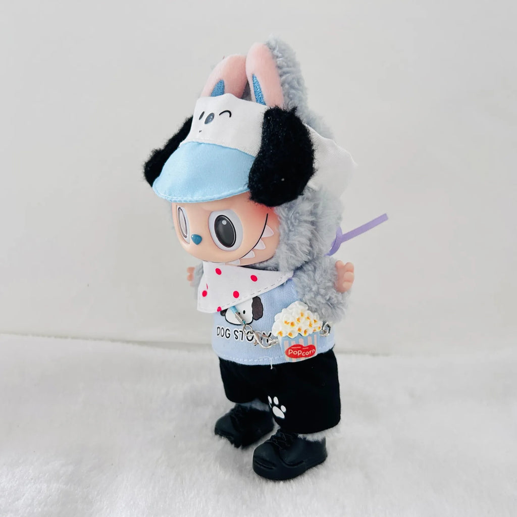 A plush toy dog dressed in a light blue visor, white bib with red polka dots, black pants, and black shoes.