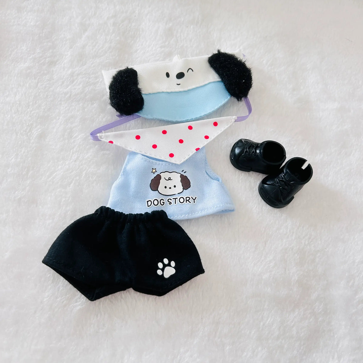A set of Labubu doll clothing and accessories, including a white and light blue dog hat, a light blue dog shirt, a red dot bib, black shorts and shoes.