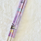 A close-up of the Kuromi pencils, purple colour decorated with Sanrio character illustrations, including Kuromi.