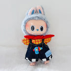 A Labubu plush doll wearing a red and yellow plaid shirt, dark blue denim-style overalls with a blue toy blaster patch.