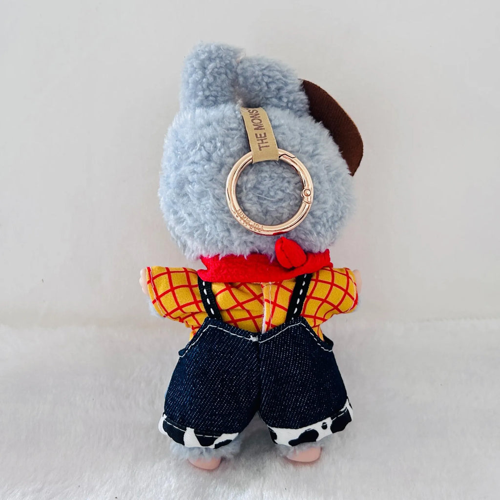 A back view of a Labubu wearing a yellow and red plaid shirt, dark blue denim overalls, and a red scarf.