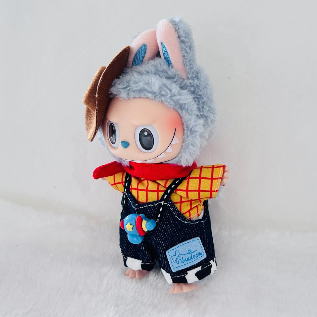 A Labubu plush doll dressed in a cowboy-inspired outfit, featuring a brown hat, a red-and-yellow plaid shirt, a red scarf, and dark denim overalls.