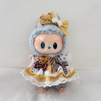 A Labubu plush doll wearing a dress with bear icon,  yellow gingham and white lace, plus a tan bow on its head.