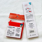 The back of view of the Hello Kitty compact  mirror and hair comb. The back of products' packages show holographic stickers. 