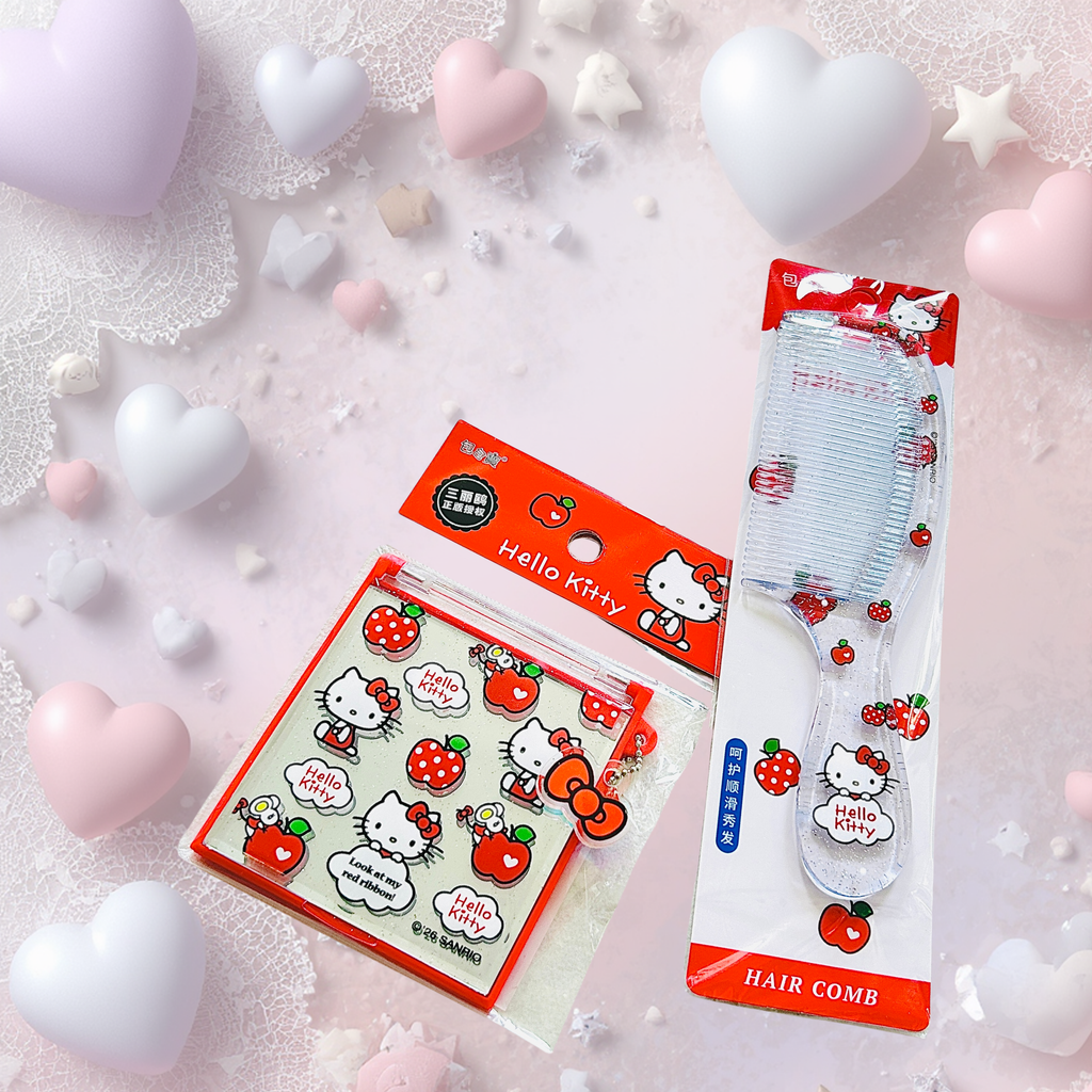 Hello Kitty strawberry-themed hair comb and matching accessories arranged on a pastel pink background with decorative heart props. 