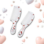 Two white hairbrushes with Hello Kitty illustrations and small red strawberry accents, arranged on a white background with pastel heart and star decorations.