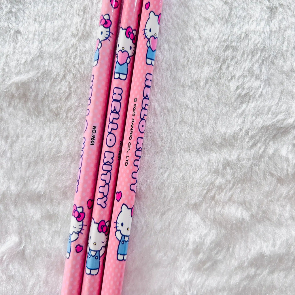 Three pink Hello Kitty pencils with cute character prints and polka dots.