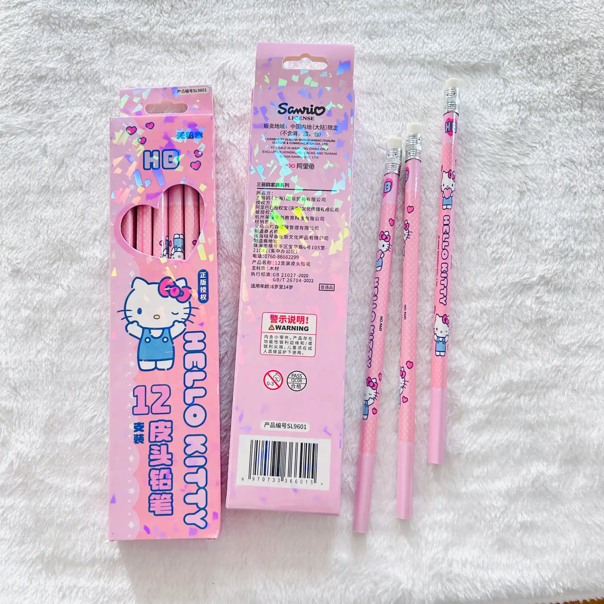 A pink Hello Kitty 12-pack pencil set with its packaging. And displaying three individual pencils decorated with Hello Kitty illustrations.