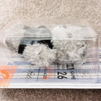A side view of a packaged Hirono Final whistle Bear in grey colour.