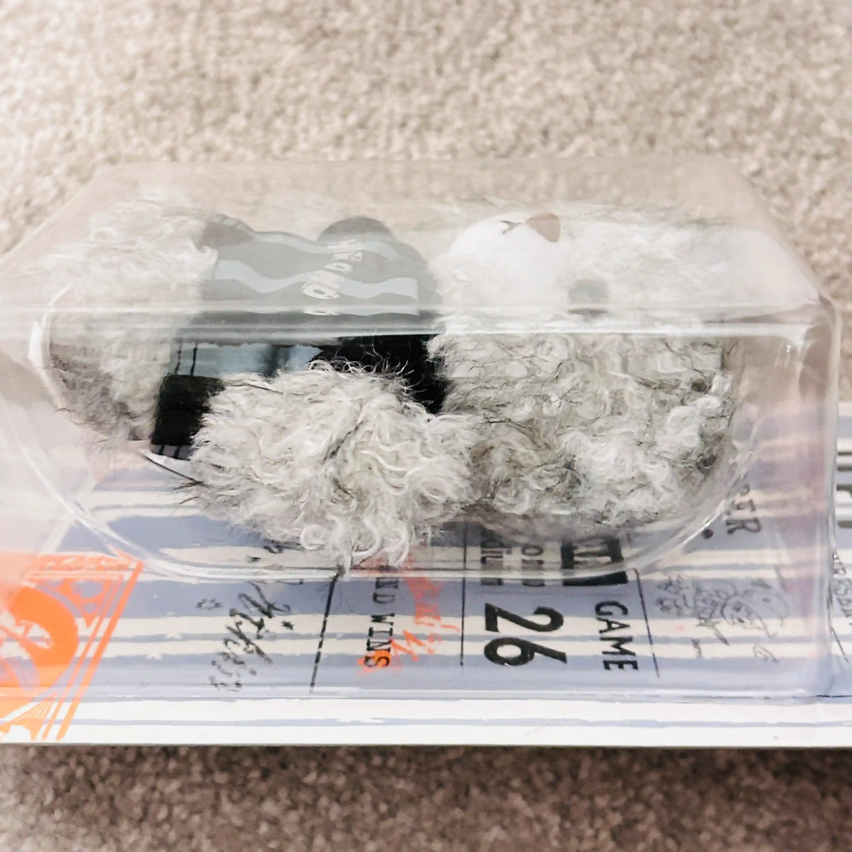 A side view of a packaged Hirono Final whistle Bear in grey colour.