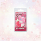 A packaged Sanrio My Melody collector's eraser keychain, shown in its original blister card packaging against a soft pink and white floral background.