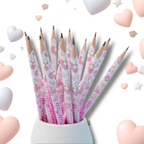 A set of pink Hello Kitty pencils arranged in a white pencil holder against a white background with floating pastel hearts and stars.