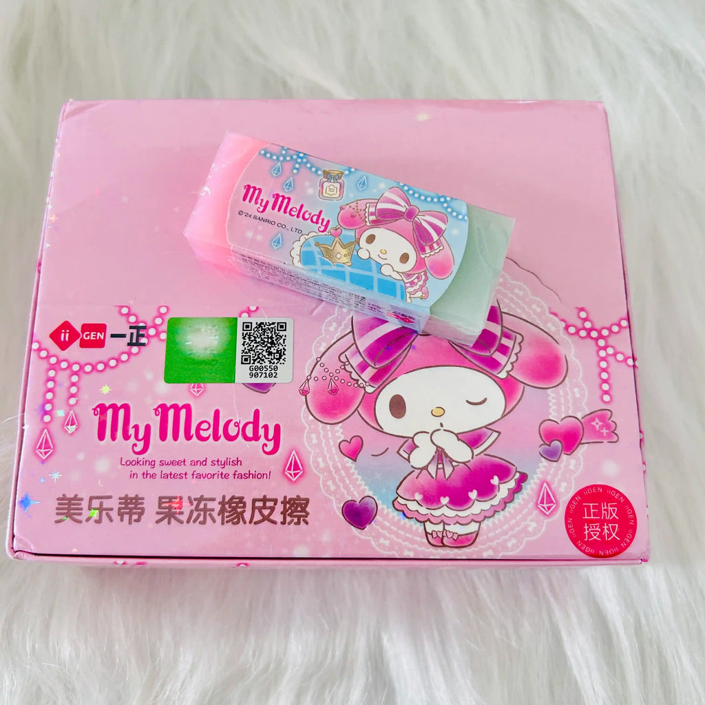 A pink and green My Melody eraser placed on it's package box with QR code. 