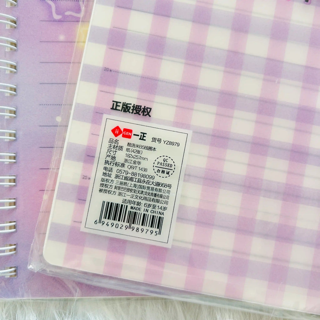 A close-up of a purple and white gingham notebook's product information label.