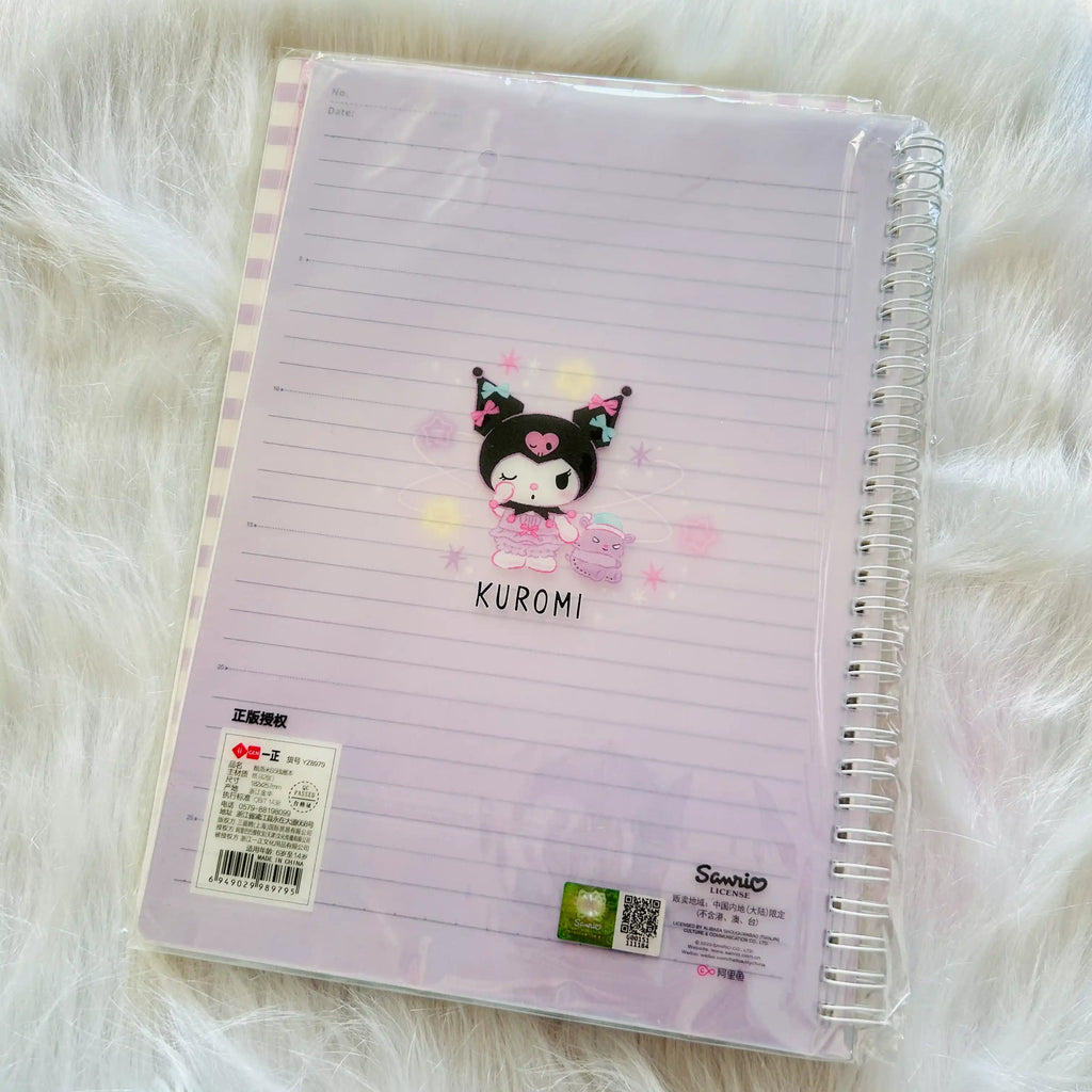 A Sanrio Kuromi lined notebook in a clear plastic sleeve. The notebook has a light lavender cover with horizontal lines, a Kuromi character illustration, and Sanrio branding.